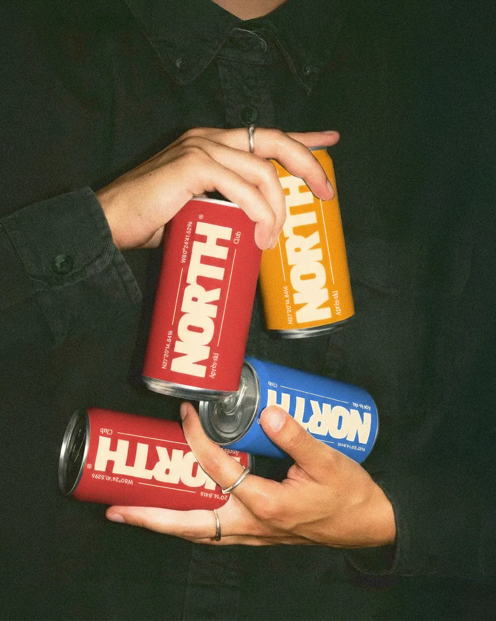 Canettes NORTH® tenues en main : identité de marque et packaging par MATE Studio
